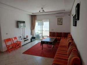 a living room with a couch and a table at Charming 2 bedrooms Appartment in Agadir nʼ Aït Sa