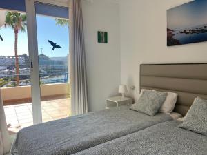 a bedroom with a bed and a large window at Toni LuXx Suite Monte Golf in Mogán +23 photos