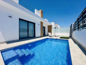 a swimming pool in the backyard of a house at El Alba in Torre-Pacheco