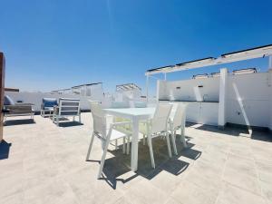 a white table and chairs on a roof at El Alba in Torre-Pacheco