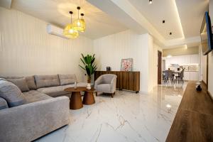 a living room with a couch and a table at Avento Lux Suites in Potos