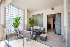 a living room with a table and chairs at Avento Lux Suites in Potos