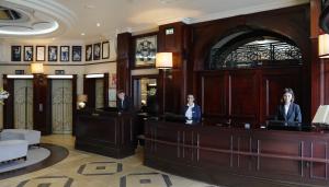 two people standing at a courtroom in a building at Hôtel Pont Royal Paris in Paris