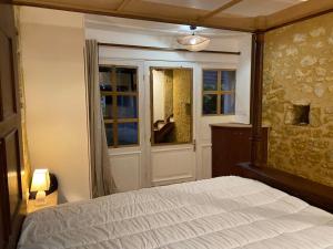 a bedroom with a bed and a window at Gîte du banc de scie in Ceton