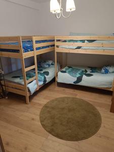 a room with three bunk beds and a rug at Casa Esther and Pepe VUT LE884 in Riego de la Vega