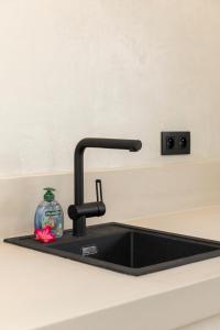 a kitchen sink with a faucet on a counter at Sorobon Bay Hotel in Kralendijk