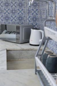 a kitchen counter with a microwave and a toaster at Joséanna in Ehden