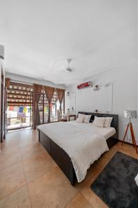 a bedroom with a large bed in a room at Jugglers Rest Boho Style 4 Bedrooms Spacez Luxury Villa in Bengaluru +55 photos