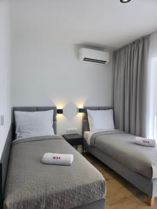 a bedroom with two beds and a window at W64 Apartamenty in Płock