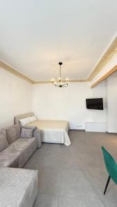 a living room with a couch and a tv at Home Apartments Five in Wuppertal