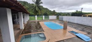 a swimming pool on a patio next to a house at Chácara Mergulho Azul in Belém +7 photos
