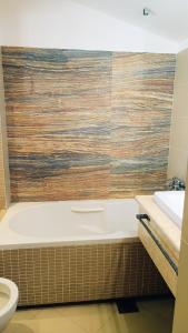 a bathroom with a tub and a toilet and a sink at Rezevici AZUR in Budva +41 photos
