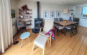 a living room with a table and chairs and a stove at Stunning Home In Lemmer With Wifi in Lemmer