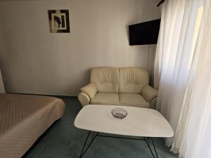 a living room with a couch and a table at Maja in Kolan