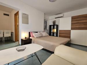 a bedroom with a bed and a table and a couch at Maja in Kolan