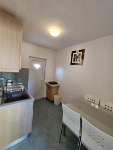 a kitchen with a sink and a table with chairs at Maja in Kolan
