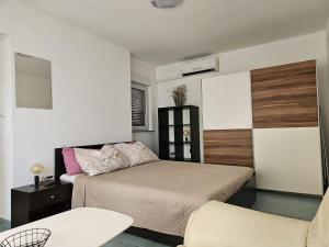a small bedroom with a bed and a chair at Maja in Kolan