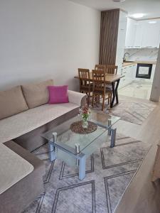 a living room with a couch and a table at Apartman L&S in Doboj