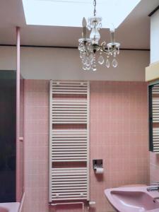 a bathroom with a sink and a chandelier at Vintage charm with comfort in Bernkastel-Kues +24 photos