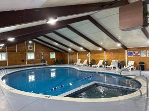 a large swimming pool with chairs in a building at The Bridgeway in Bourne