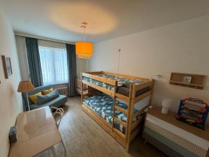 Ένα ή περισσότερα κρεβάτια σε δωμάτιο στο Appartement spacieux & familial à 400m de la plage d'Ostende 2 chambres avec patio by La Conciergerie