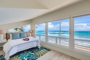 a bedroom with a view of the ocean at Haena Beach House TVNC#1258 in Hanalei