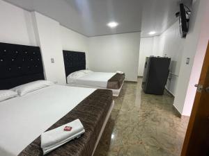 Un ou plusieurs lits dans un hébergement de l'établissement Hotel maripipark
