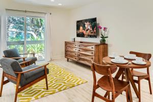 a living room with a table and chairs at Haena Beach House TVNC#1258 in Hanalei +9 photos