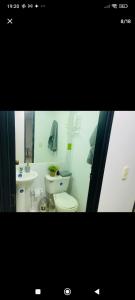 a bathroom with a white toilet and a sink at Apartamento en Barranquilla in Barranquilla