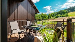 a patio with a table and chairs on a deck at Wiking in Skorka