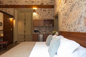 a bedroom with a large bed and a kitchen at CASA SAUTO 2 BR 2BA balcony Historic Building in Mexico City