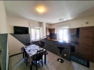 a kitchen with a table and chairs in a room at Case Gemelle - CIR 0271 in Aosta