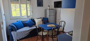 a living room with a couch and a table and a refrigerator at Apartments Villa Andreja in Starigrad