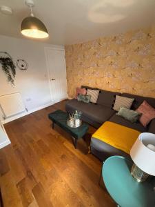 a living room with a couch and a table at Fresh comfy space, feel at home. in Gravesend
