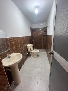 a bathroom with a toilet and a sink at Zzi in Lamas +8 photos