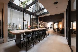 a long dining room with a long table and chairs at Eisenhut Boutique Hotel in Bolzano