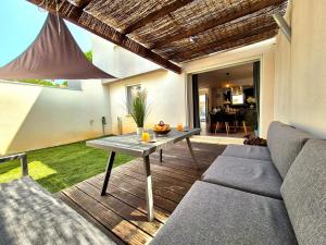 un salon avec un canapé et une table dans l'établissement La Maison des Iris - clim - patio - parking, à Nîmes