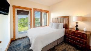 a bedroom with a white bed and a window at Avon Pier - 2-Bedroom, 2-Bathroom Suite at REAL Watersports in Waves