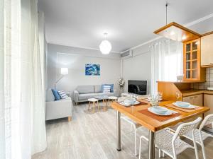 a kitchen and living room with a table and chairs at Menidi by the sea in Menídion
