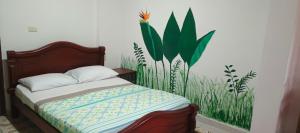 a bedroom with a bed with a painting on the wall at Finca MI FUNDO in Acacías +32 photos