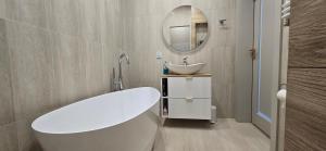 a bathroom with a white tub and a sink at Nowoczesna Willa in Wrocław +25 photos