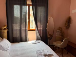a bedroom with a bed and a mirror and a window at Mistral Holidays - Minisuite con Terrazzino in Marina di Carrara