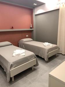 a hospital room with two beds with towels on them at B&B The Princess accanto all'Aeroporto di Salerno-Costa D'Amalfi in Bellizzi
