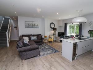 a kitchen and living room with a couch and a table at Beach Hideaway in Bideford