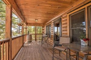 a wooden deck with a table and chairs on it at Cozy Noras Hideaway - Charming, Quiet Log Cabin in Duck Creek Village