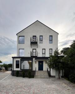 a large white house with a blue door at Mosh Mosh Boutique Hotel in Almaty +68 photos