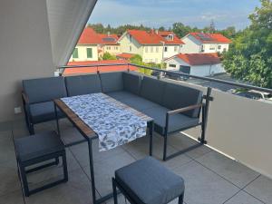 a table and chairs on a balcony with a view at Ferien Penthaus Wohnung Brunnthal in Brunnthal