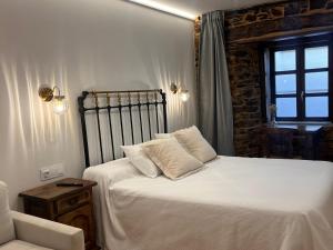 Ein Bett oder Betten in einem Zimmer der Unterkunft Cantábrico Fonsagrada