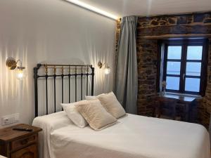 Ein Bett oder Betten in einem Zimmer der Unterkunft Cantábrico Fonsagrada
