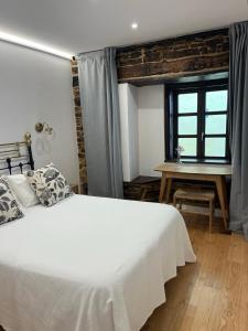 Ein Bett oder Betten in einem Zimmer der Unterkunft Cantábrico Fonsagrada